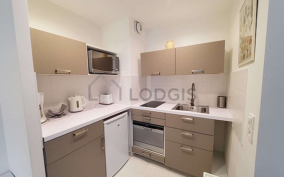 Kitchen equipped with dishwasher, hob, refrigerator, crockery