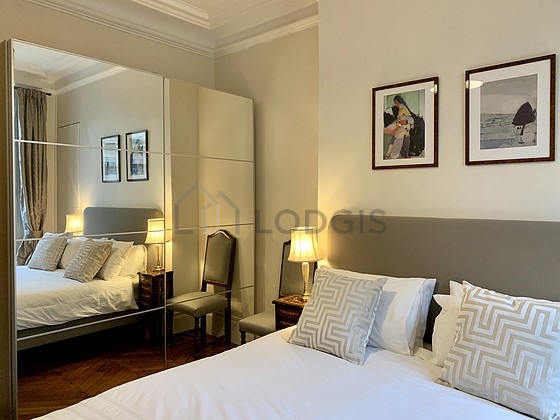 Bright bedroom equipped with closet, storage space, cupboard, 1 chair(s)