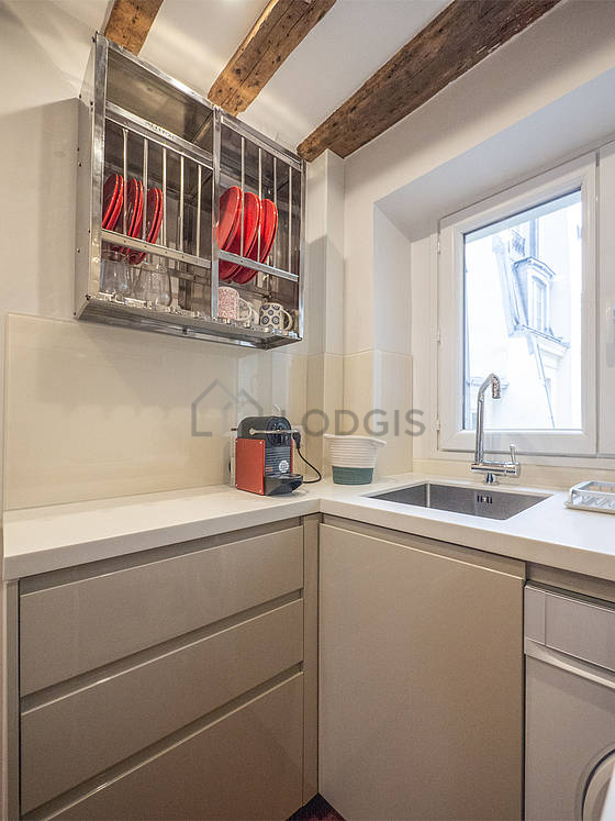 Kitchen equipped with washing machine, refrigerator, freezer, extractor hood