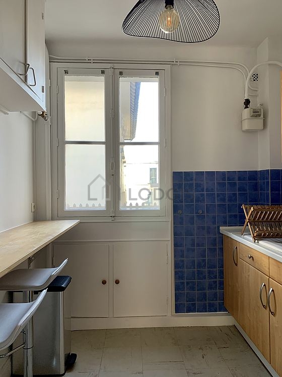 Kitchen equipped with hob, refrigerator, extractor hood, crockery