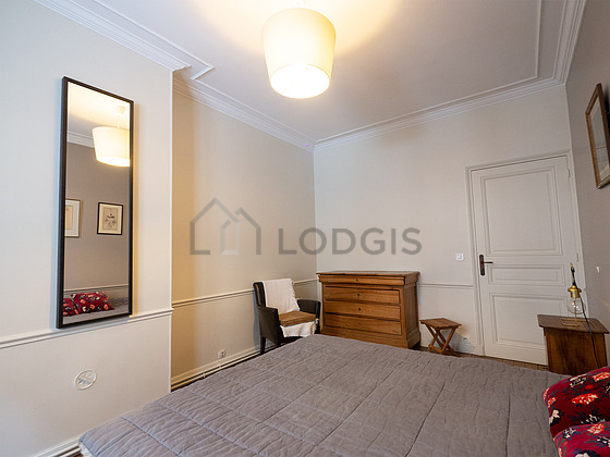Very bright bedroom equipped with 1 armchair(s), stool