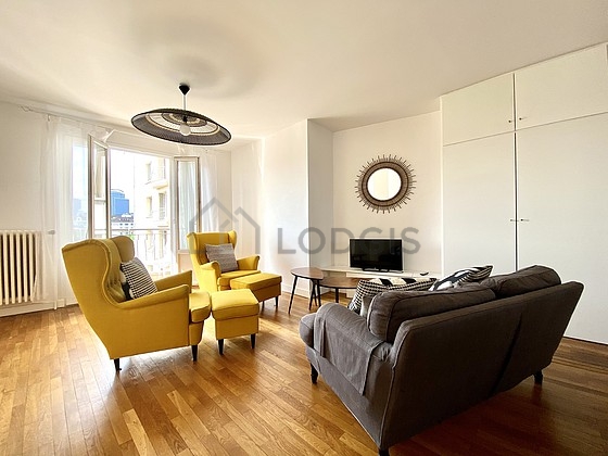 Living room furnished with tv, 2 armchair(s)