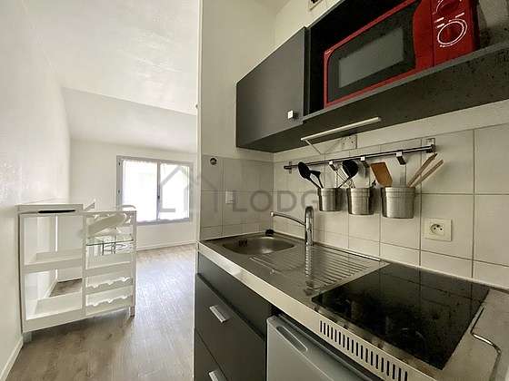 Kitchen equipped with hob, refrigerator