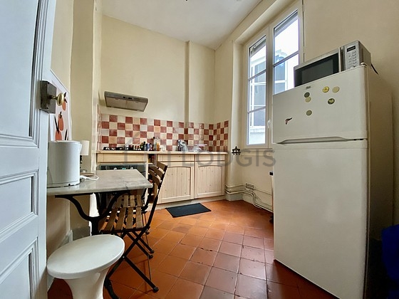 Kitchen equipped with hob, refrigerator, extractor hood