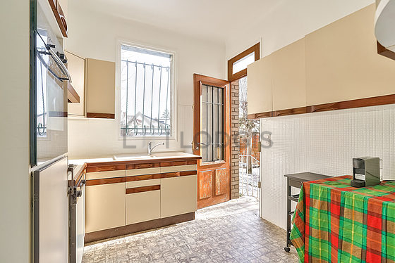 Kitchen equipped with dishwasher, hob, refrigerator, extractor hood