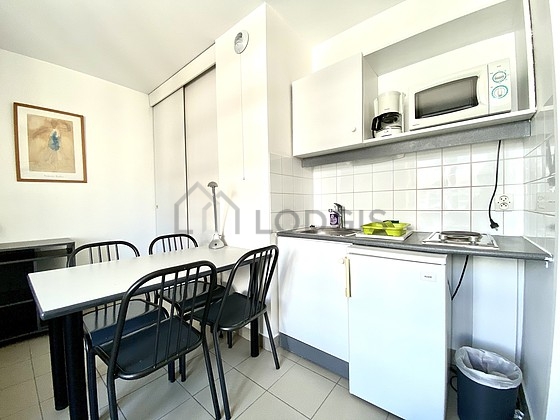 Kitchen equipped with hob, refrigerator, crockery