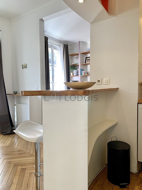 Kitchen equipped with crockery, stool