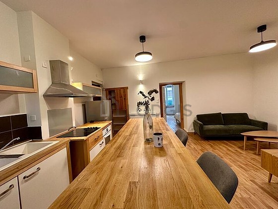 Kitchen equipped with hob, refrigerator, crockery, stool