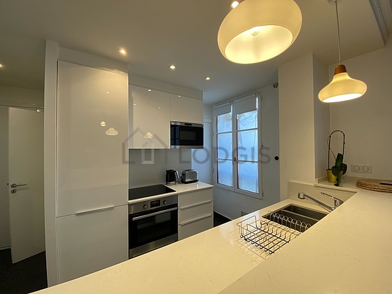 Kitchen equipped with washing machine, refrigerator, crockery