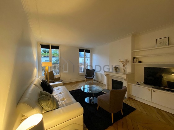 Living room with windows and balcony facing the road