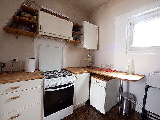 Kitchen equipped with washing machine, refrigerator, crockery