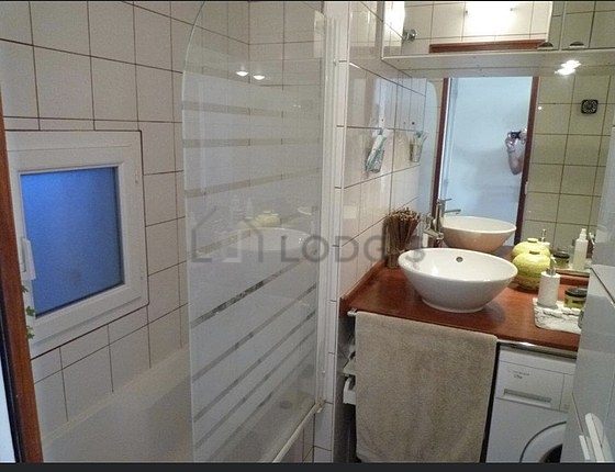 Bathroom equipped with washing machine, bath towels