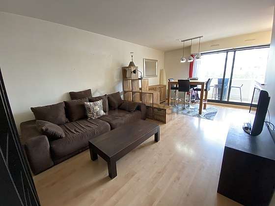 Living room furnished with sofa, coffee table, storage space