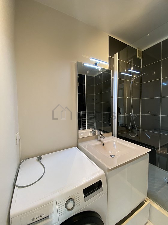 Bathroom equipped with washing machine, separate shower