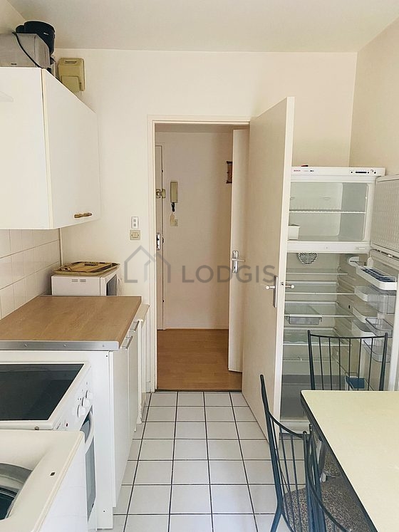 Kitchen equipped with washing machine, refrigerator, crockery