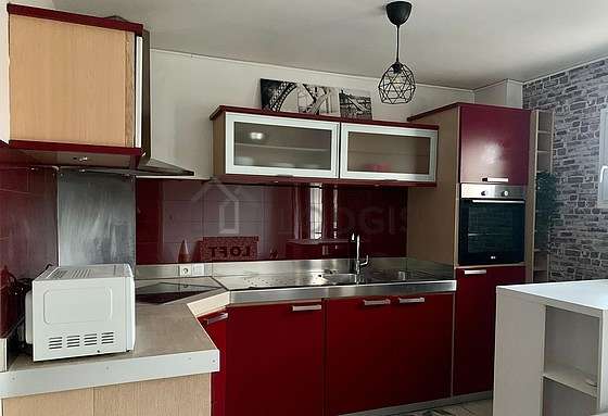 Kitchen equipped with hob, refrigerator, extractor hood