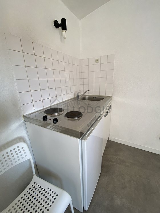 Kitchen equipped with hob, refrigerator, crockery