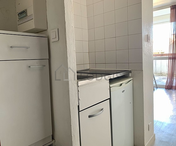 Kitchen equipped with hob, refrigerator, crockery