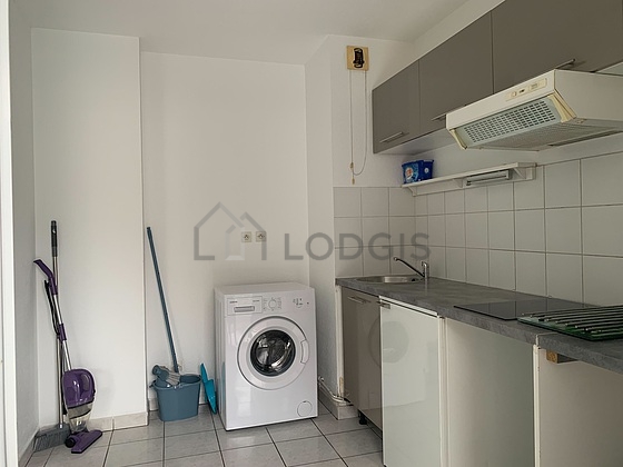 Kitchen equipped with washing machine, refrigerator, extractor hood