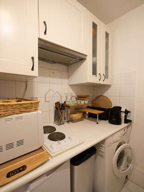 Kitchen equipped with washing machine, refrigerator, freezer, crockery
