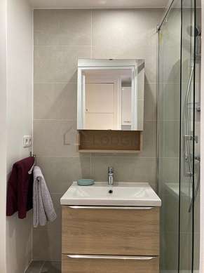 Bathroom equipped with washing machine, separate shower
