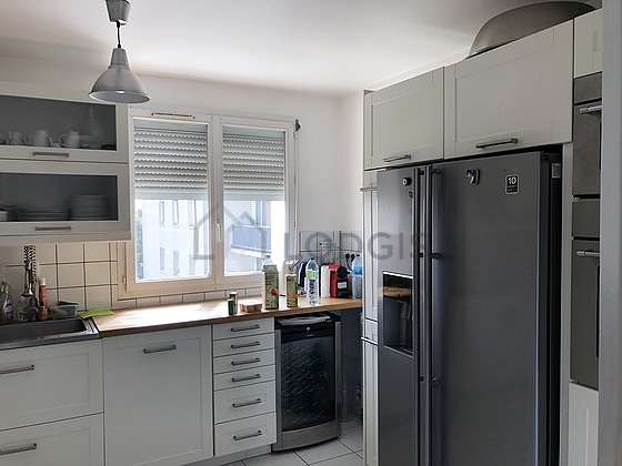 Kitchen equipped with dryer, refrigerator, freezer, extractor hood
