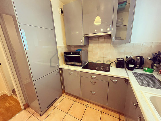 Kitchen equipped with washing machine, dryer, extractor hood, crockery