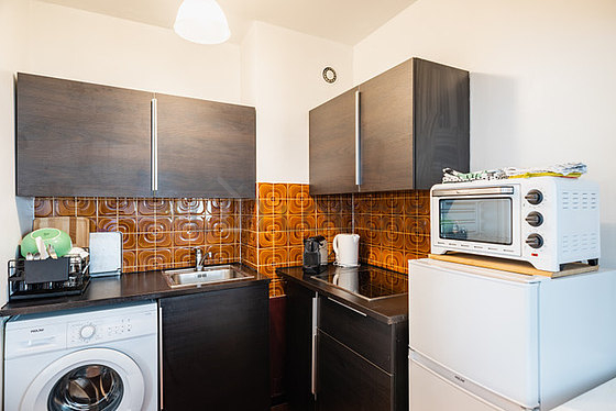 Kitchen equipped with washing machine, refrigerator, freezer, crockery