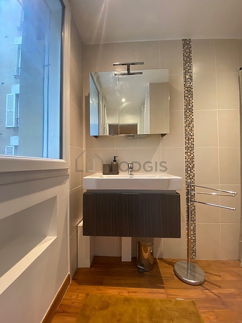 Pleasant and very bright bathroom with wooden floor