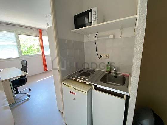 Kitchen equipped with hob, refrigerator