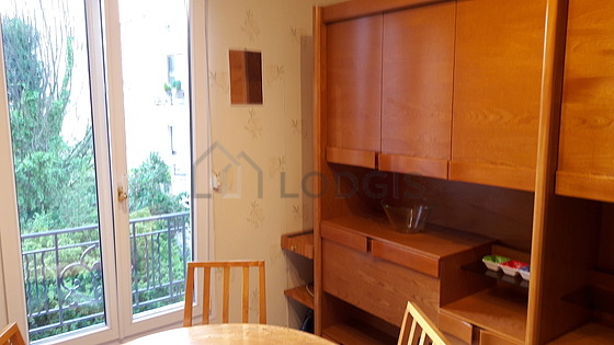 Kitchen equipped with hob, refrigerator, extractor hood, crockery