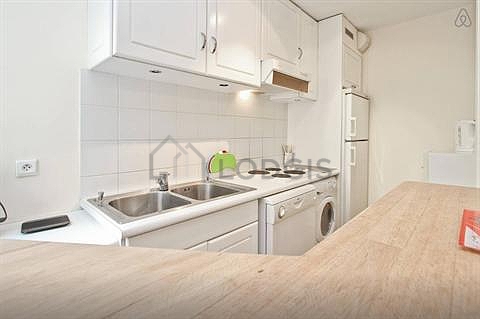 Kitchen equipped with washing machine, refrigerator, extractor hood