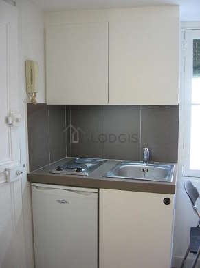 Kitchen equipped with hob, refrigerator, crockery
