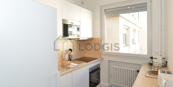 Kitchen equipped with washing machine, refrigerator, extractor hood