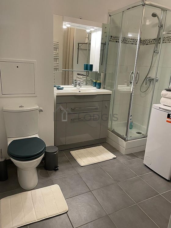 Bathroom equipped with washing machine, cupboard