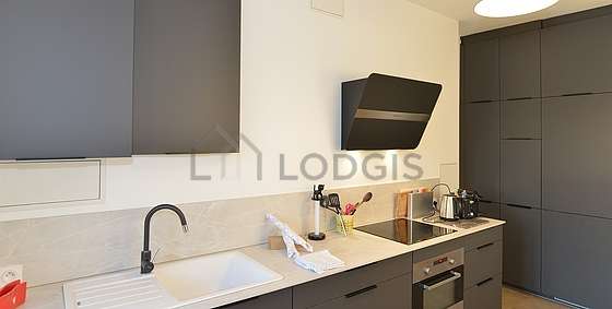 Kitchen equipped with washing machine, refrigerator, extractor hood