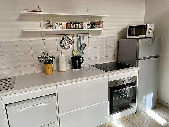 Kitchen equipped with dishwasher, hob, refrigerator