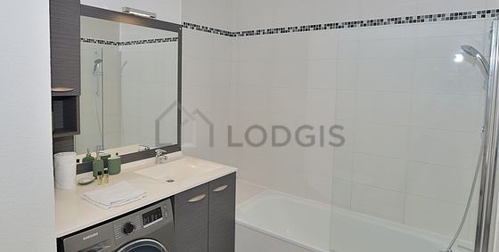 Bathroom equipped with washing machine, cupboard