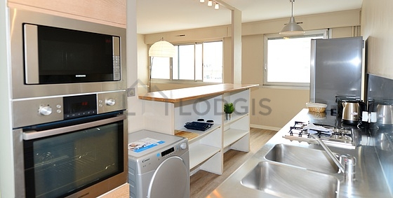 Kitchen equipped with washing machine, refrigerator, extractor hood