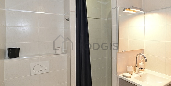 Bathroom equipped with washing machine, separate shower, towel drying radiator