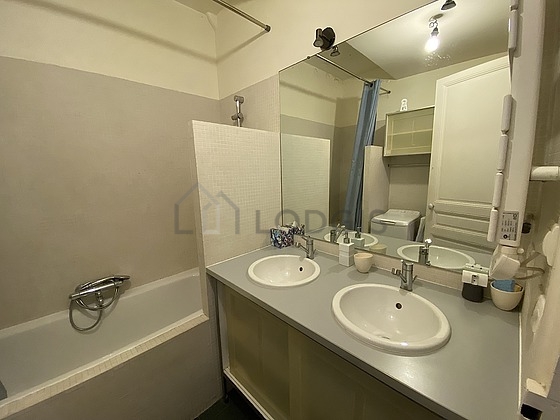 Bathroom equipped with washing machine, cupboard