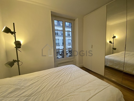 Bright bedroom equipped with wardrobe, cupboard, bedside table