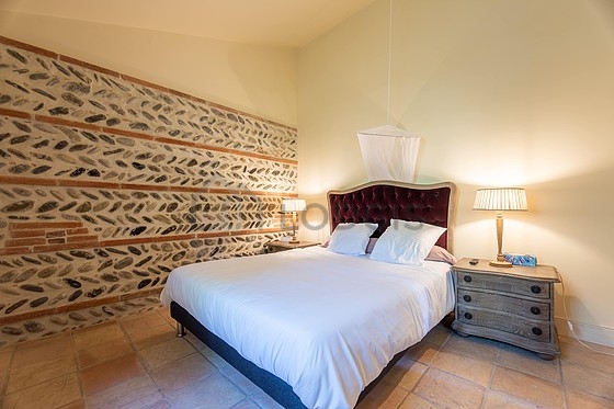 Very bright bedroom equipped with storage space, bedside table