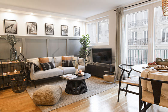 Living room furnished with tv, storage space