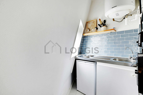 Kitchen equipped with hob, refrigerator