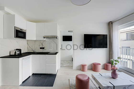 Kitchen equipped with washing machine, refrigerator, extractor hood