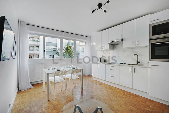 Kitchen equipped with hob, refrigerator, extractor hood, crockery