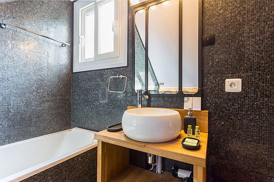 Bathroom equipped with washing machine, hair-dryer