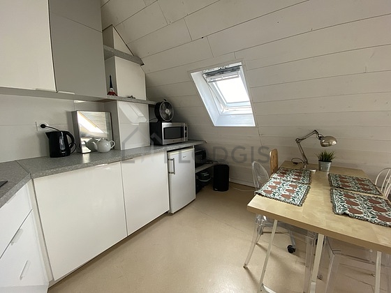 Kitchen equipped with washing machine, refrigerator, extractor hood, crockery