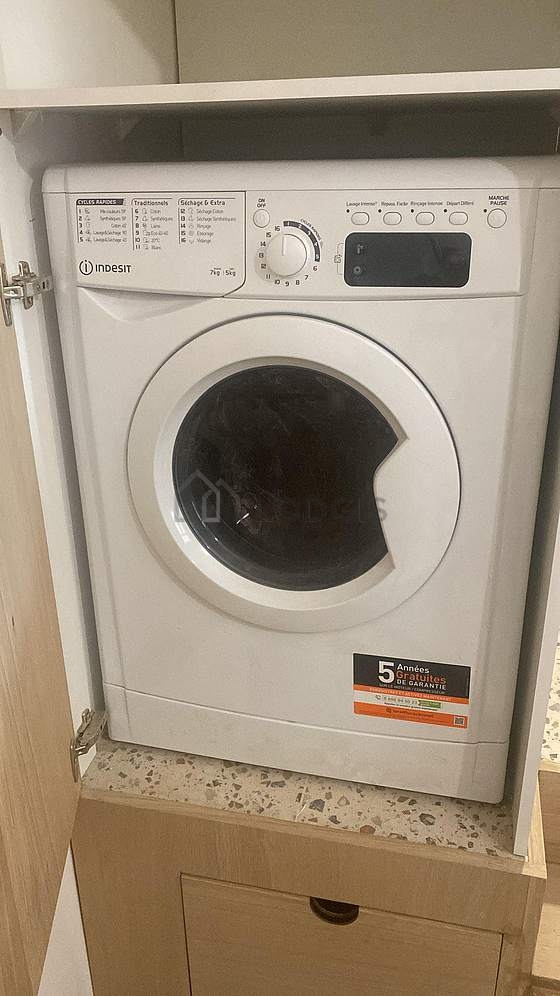 Kitchen equipped with washing machine, dryer, refrigerator, extractor hood